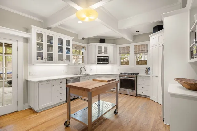 a kitchen with a stove a sink and a refrigerator