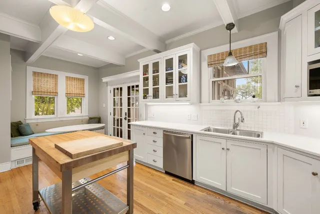 a kitchen with a sink stove and cabinets