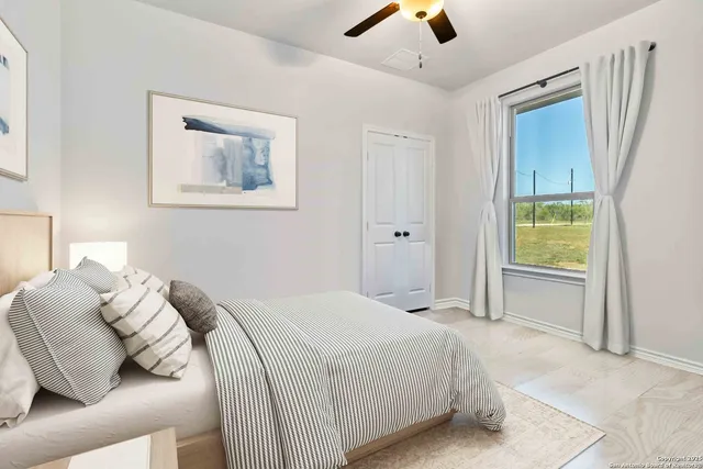 a bedroom with a bed and a painting on the wall