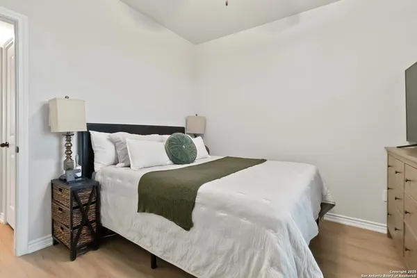 a bedroom with a bed and a night stand