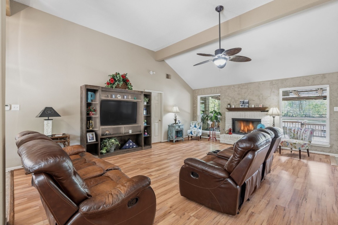 a living room with furniture a fireplace and a flat screen tv