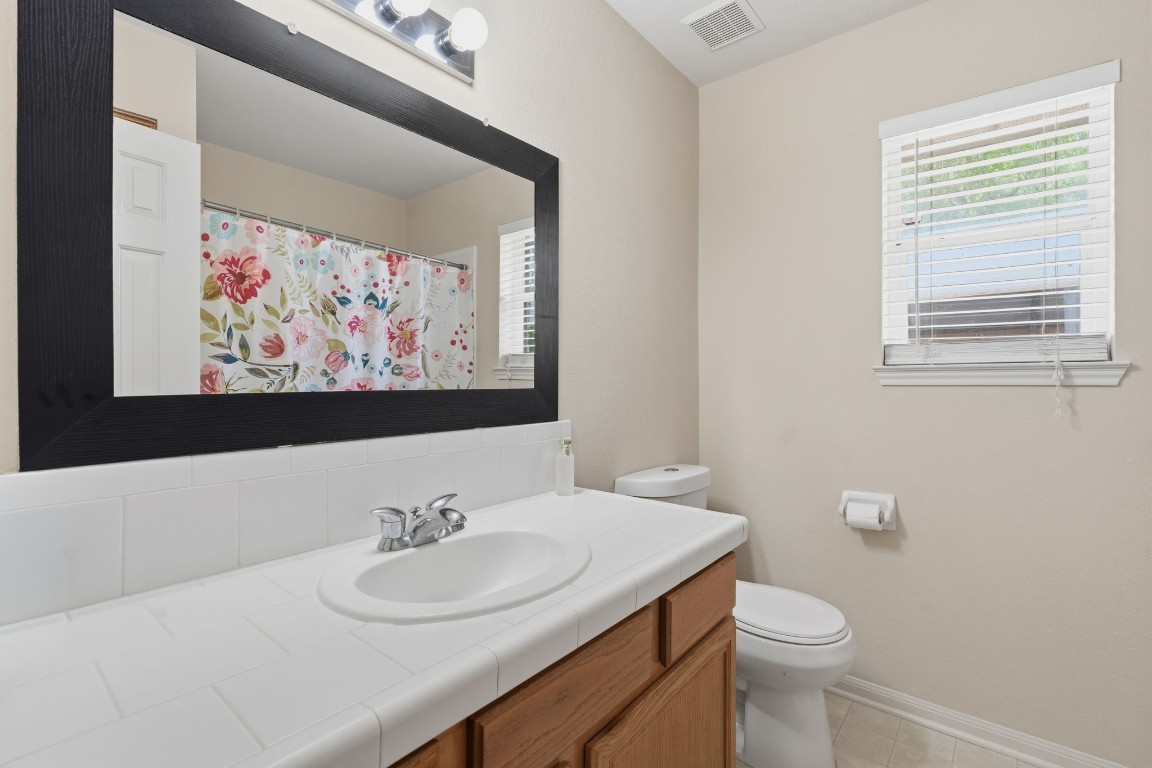 907 Columbia River Road Montgomery, TX 77316 - Photo 13 of 34 a bathroom with a toilet a sink and mirror