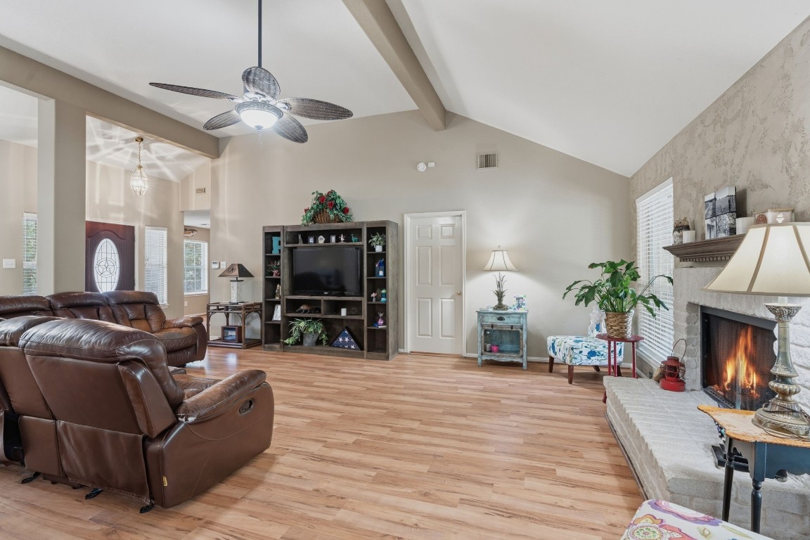 907 Columbia River Road Montgomery, TX 77316 - Photo 2 of 34 a living room with furniture a fireplace and a chandelier