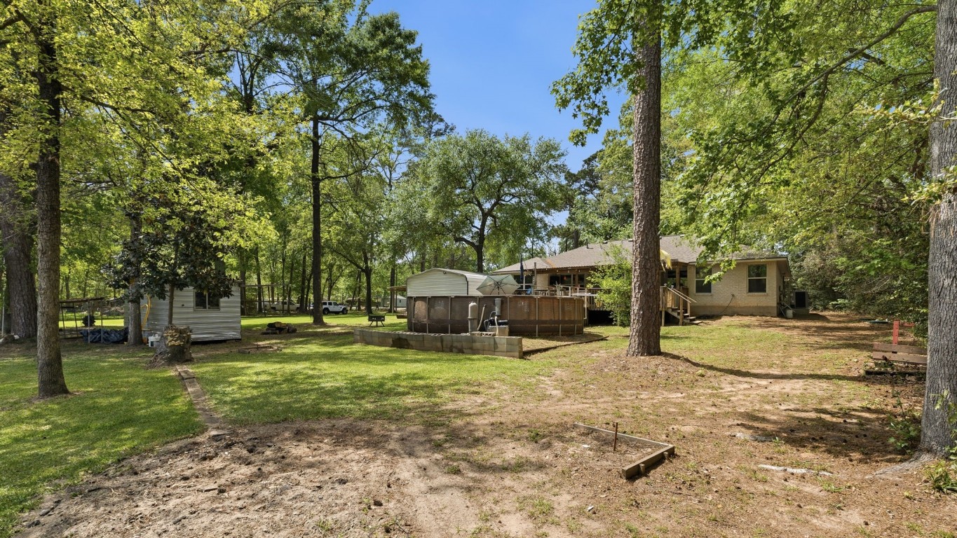 907 Columbia River Road Montgomery, TX 77316 - Photo 23 of 34 a view of a backyard with large trees
