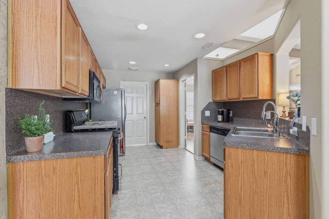 907 Columbia River Road Montgomery, TX 77316 - Photo 8 of 34 a kitchen with stainless steel appliances granite countertop a stove a sink a refrigerator and a microwave