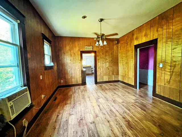 a view of a room with wooden floor and stairs
