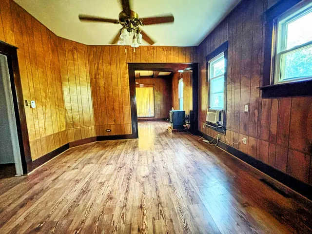 a view of a room with wooden floor and stairs
