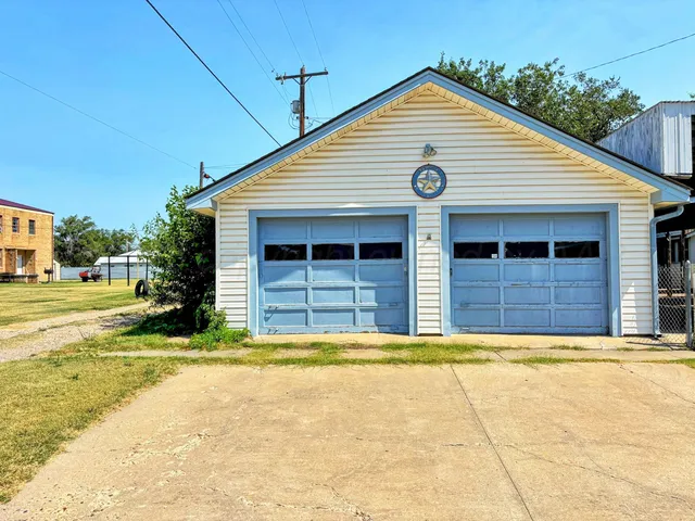a backyard of a house with a fountain swing and outdoor seating