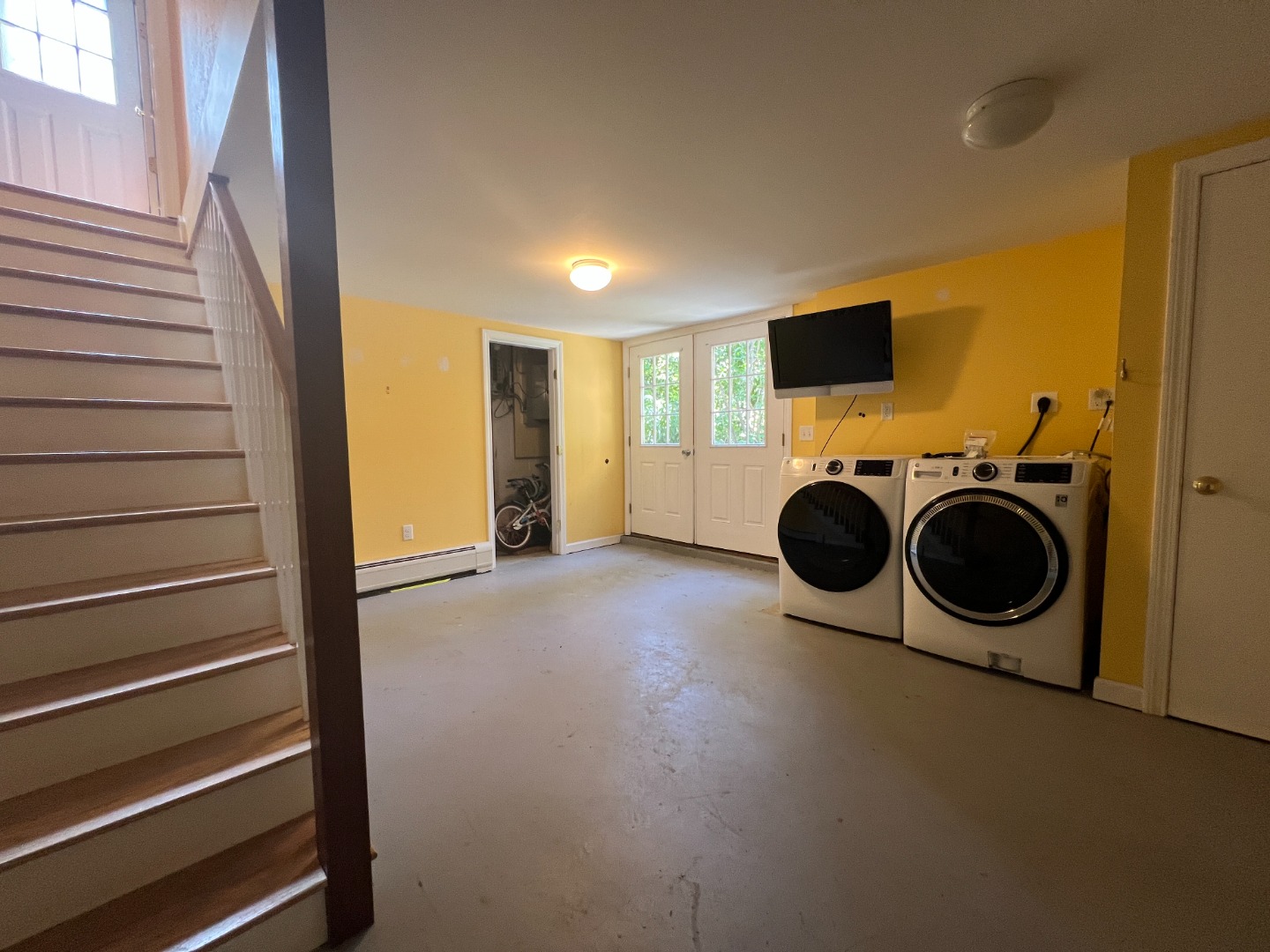 67 12th Street Edgartown, MA 02539 - Photo 17 of 23 a view of a storage & utility room with washer and dryer