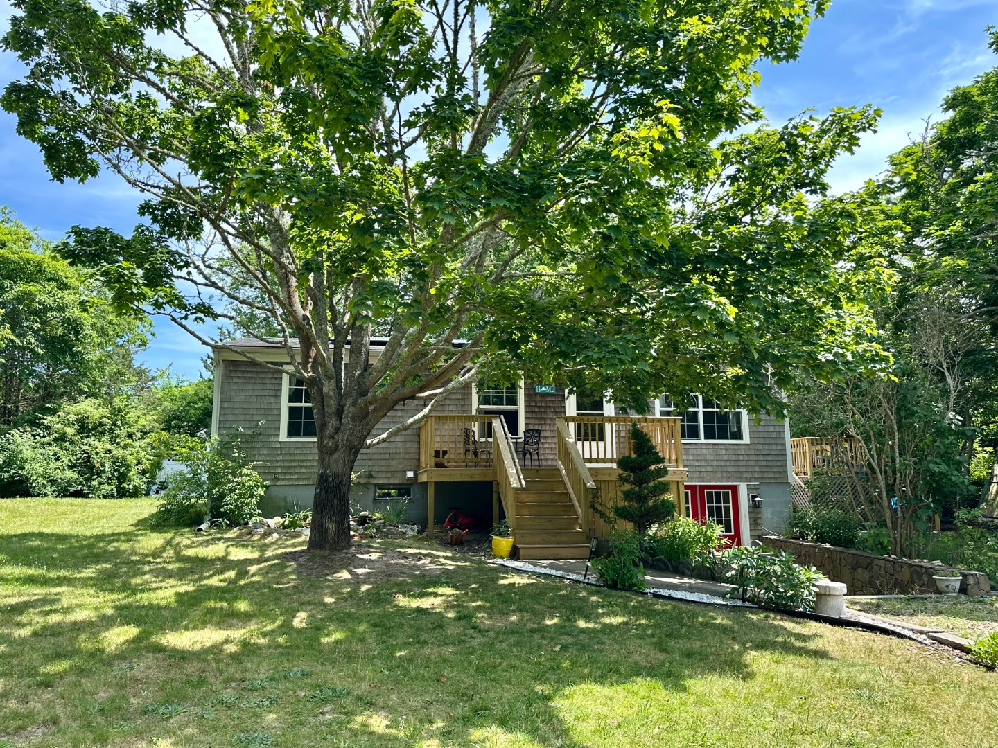 67 12th Street Edgartown, MA 02539 - Photo 2 of 23 a front view of house with yard and green space