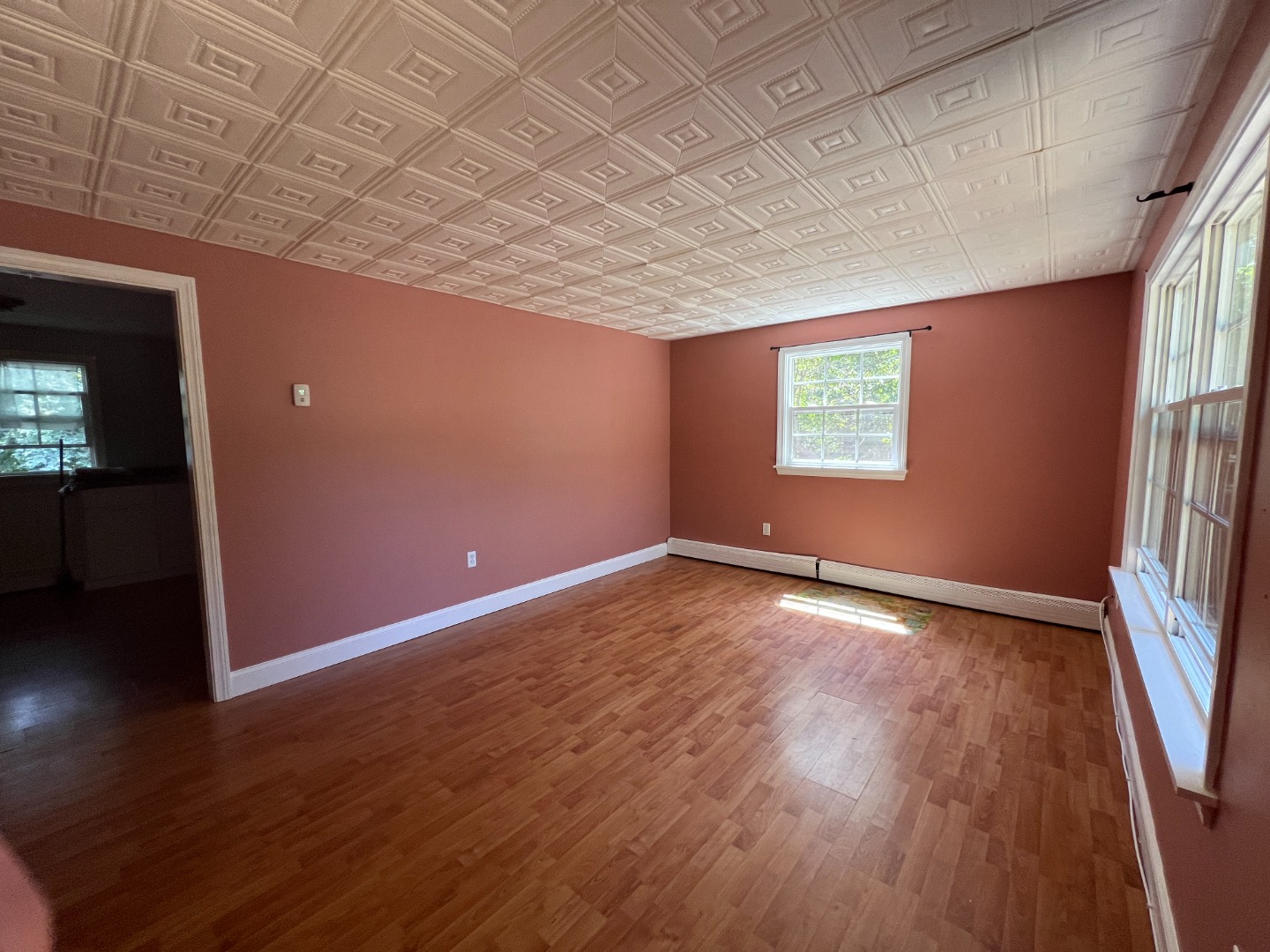 67 12th Street Edgartown, MA 02539 - Photo 5 of 23 an empty room with wooden floor and windows