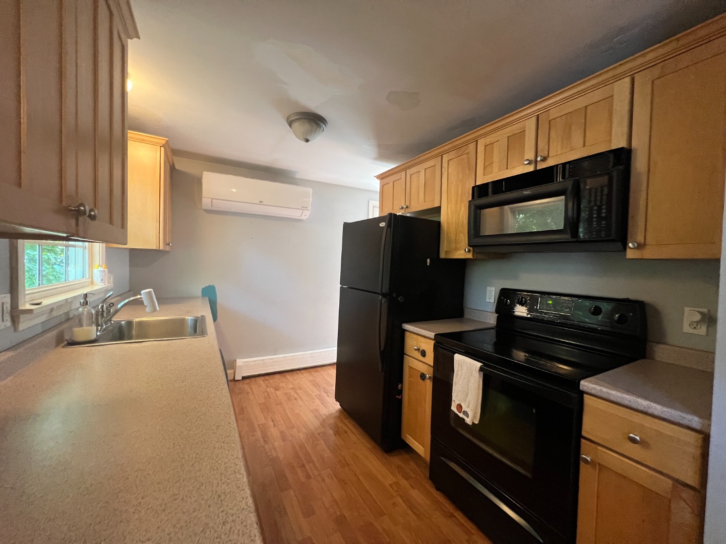 67 12th Street Edgartown, MA 02539 - Photo 8 of 23 a kitchen with granite countertop wooden cabinets and stainless steel appliances