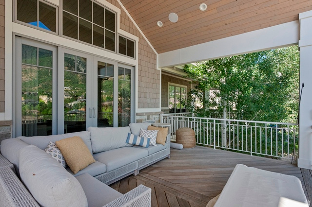 3 Carriagewood Cove, Unit 1088 Sandy, UT 84092 - Photo 6 of 79 Spacious covered deck featuring wood-finish flooring, a white metal railing, and a tongue-and-groove ceiling with recessed lighting