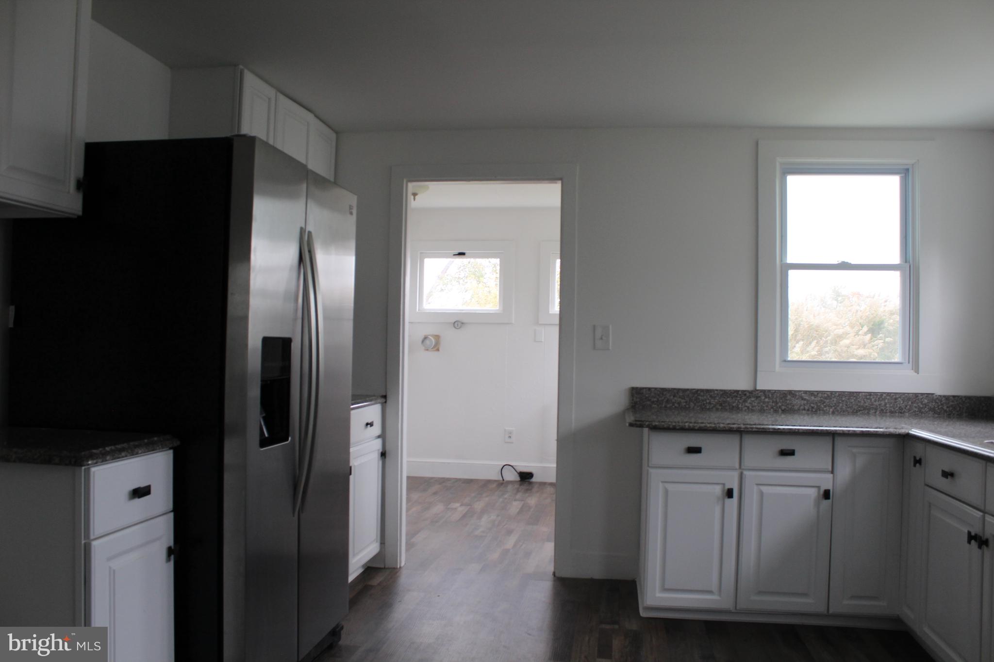 150 Main Street Dover, DE 19901 - Photo 13 of 50 a kitchen with stainless steel appliances granite countertop a refrigerator and a sink