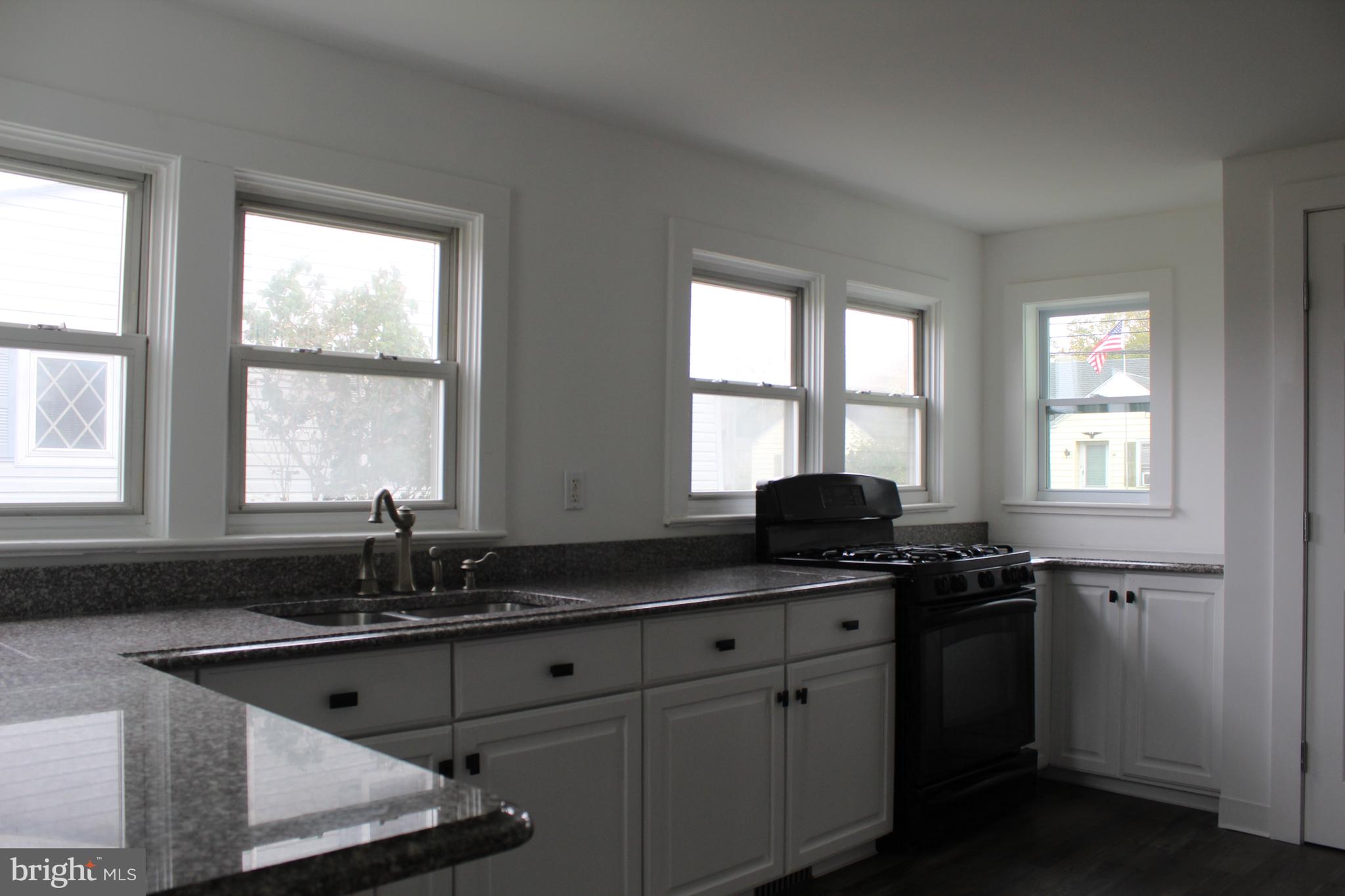 150 Main Street Dover, DE 19901 - Photo 15 of 50 a kitchen with granite countertop a sink and a window