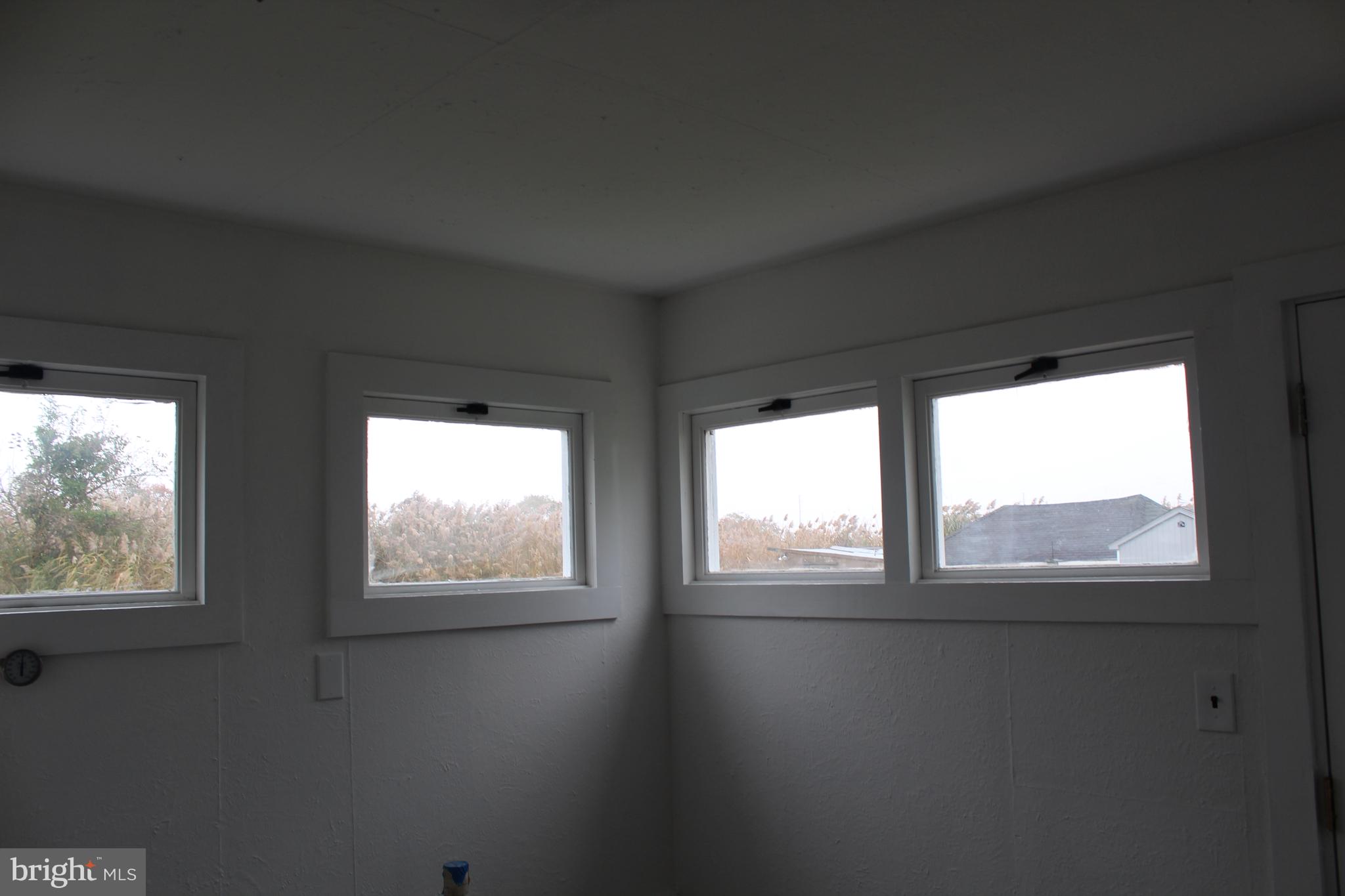 150 Main Street Dover, DE 19901 - Photo 24 of 50 a view of an empty room with wooden floor and windows