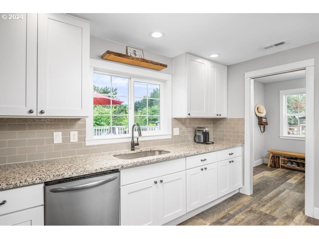 17762 South Redland Road Oregon City, OR 97045 - Photo 11 of 37 a kitchen with granite countertop a sink white cabinets and window