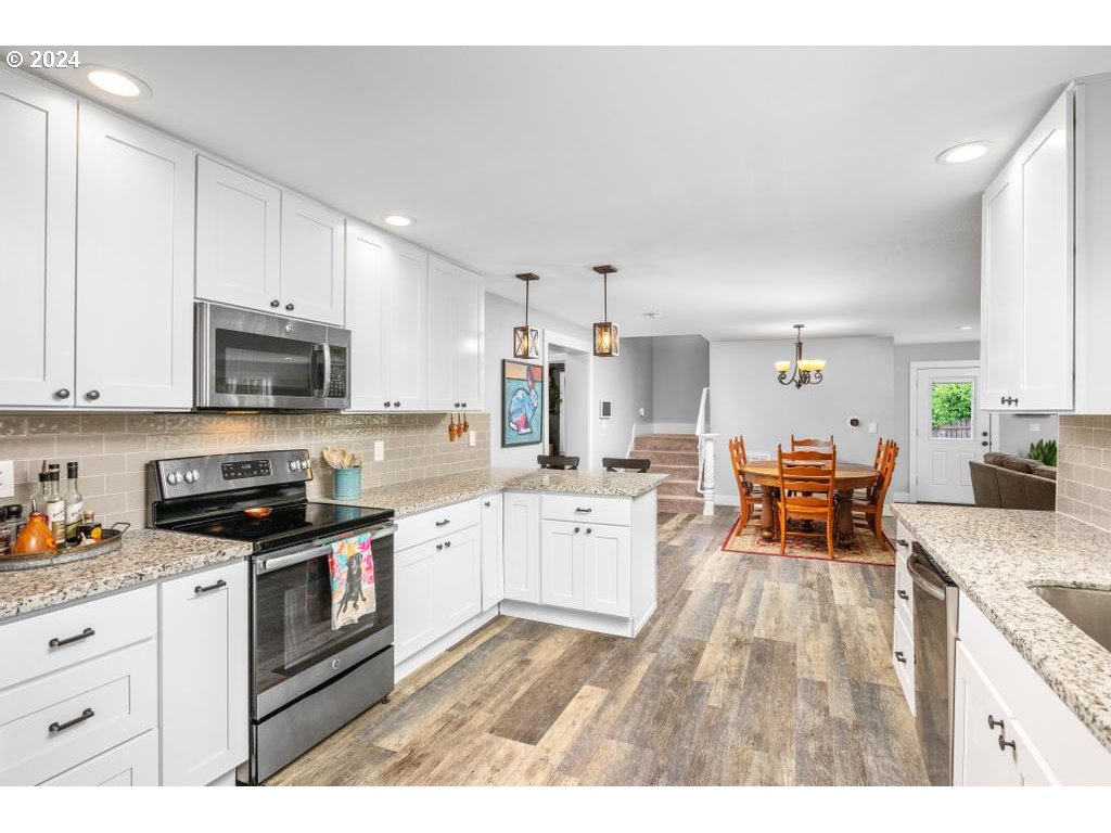 17762 South Redland Road Oregon City, OR 97045 - Photo 12 of 37 a open kitchen with granite countertop lots of white cabinets appliances and furniture