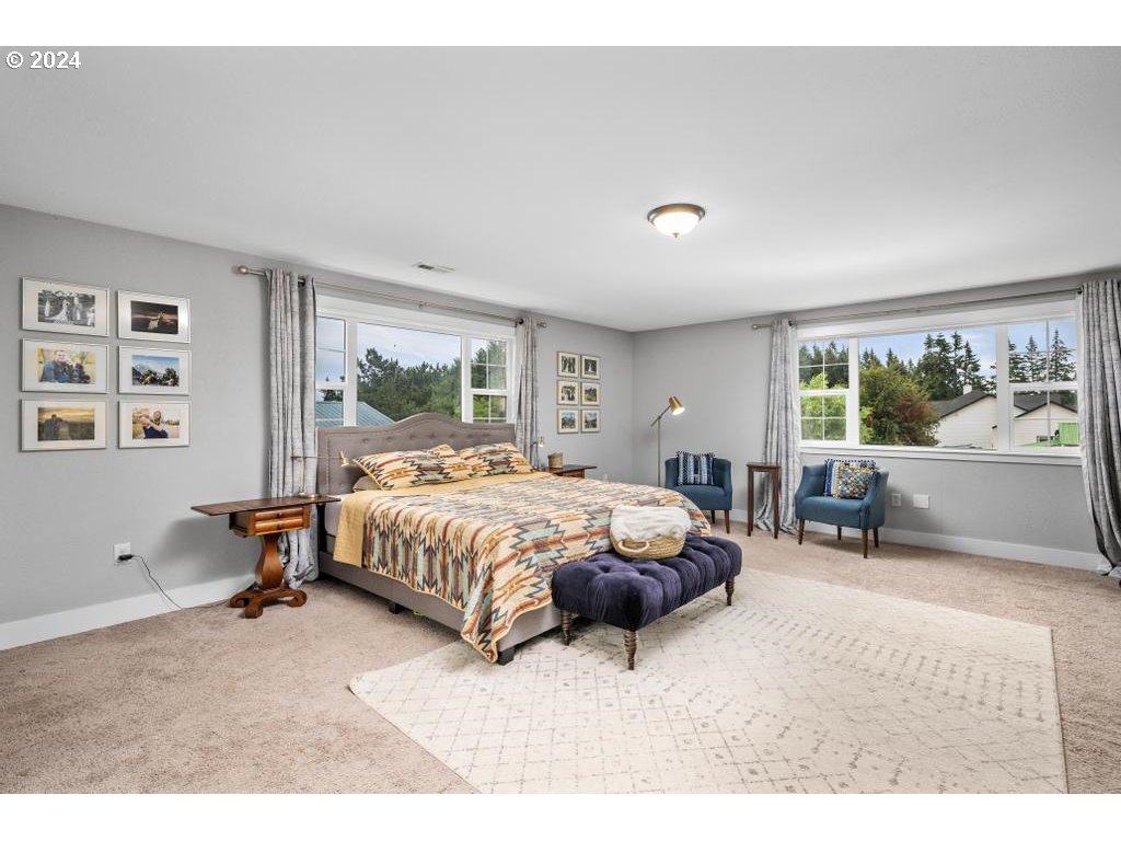 17762 South Redland Road Oregon City, OR 97045 - Photo 18 of 37 a spacious bedroom with a bed and a large window