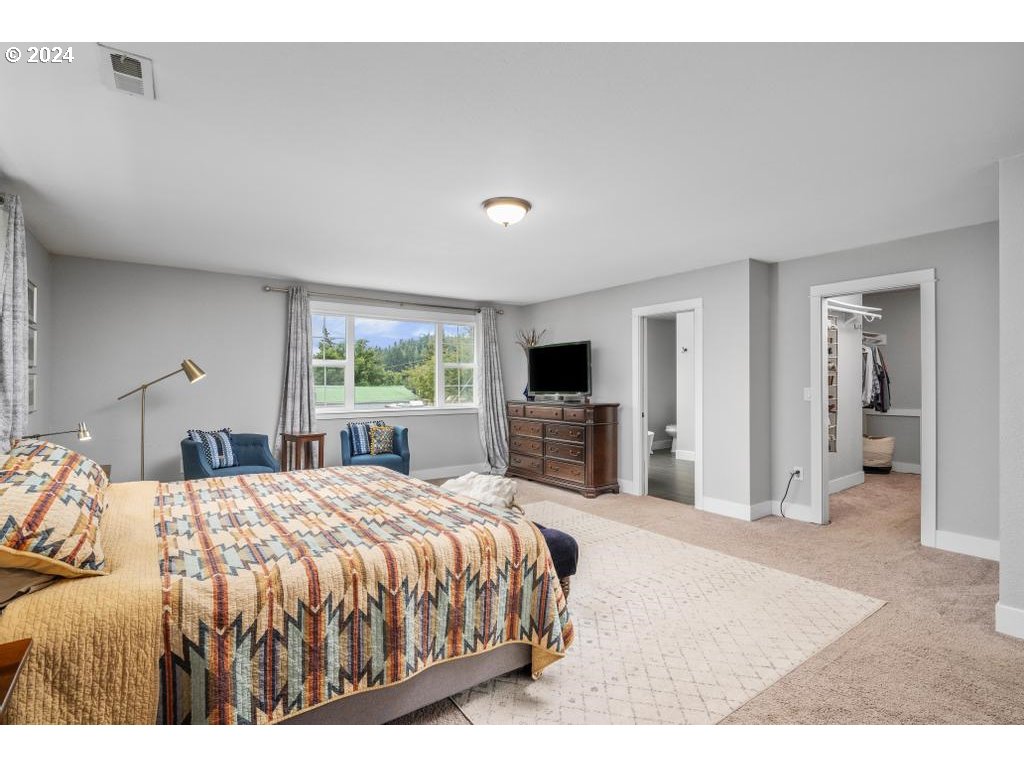 17762 South Redland Road Oregon City, OR 97045 - Photo 19 of 37 a large bedroom with a bed and a flat screen tv
