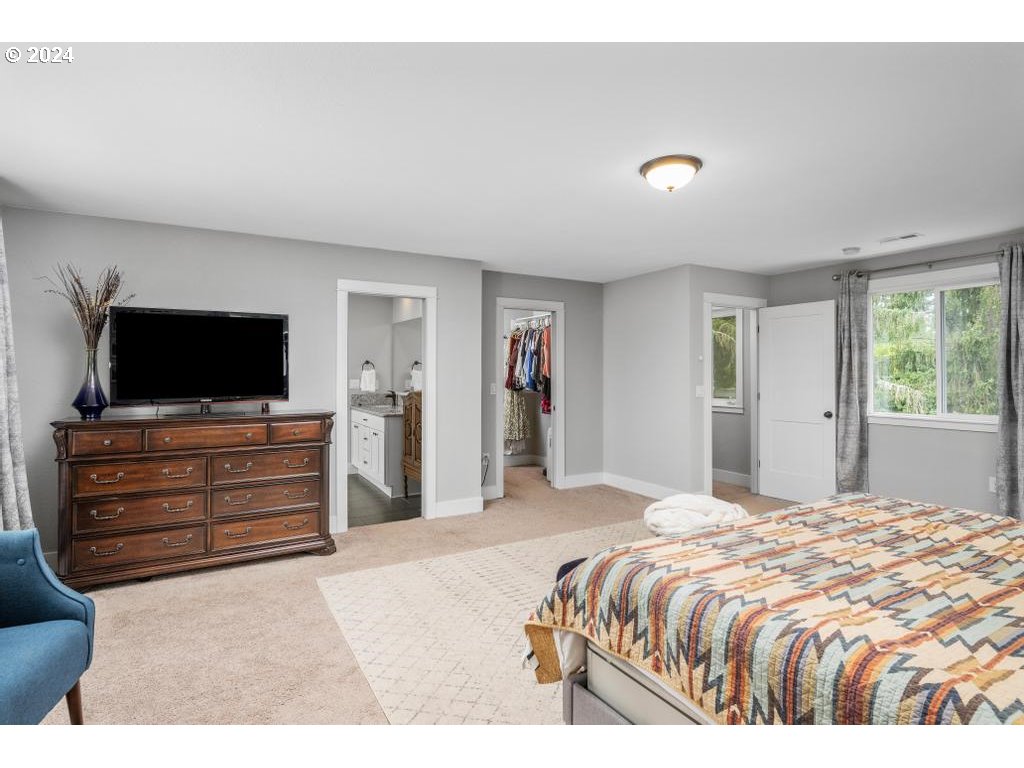 17762 South Redland Road Oregon City, OR 97045 - Photo 20 of 37 a bedroom with a bed and a flat screen tv