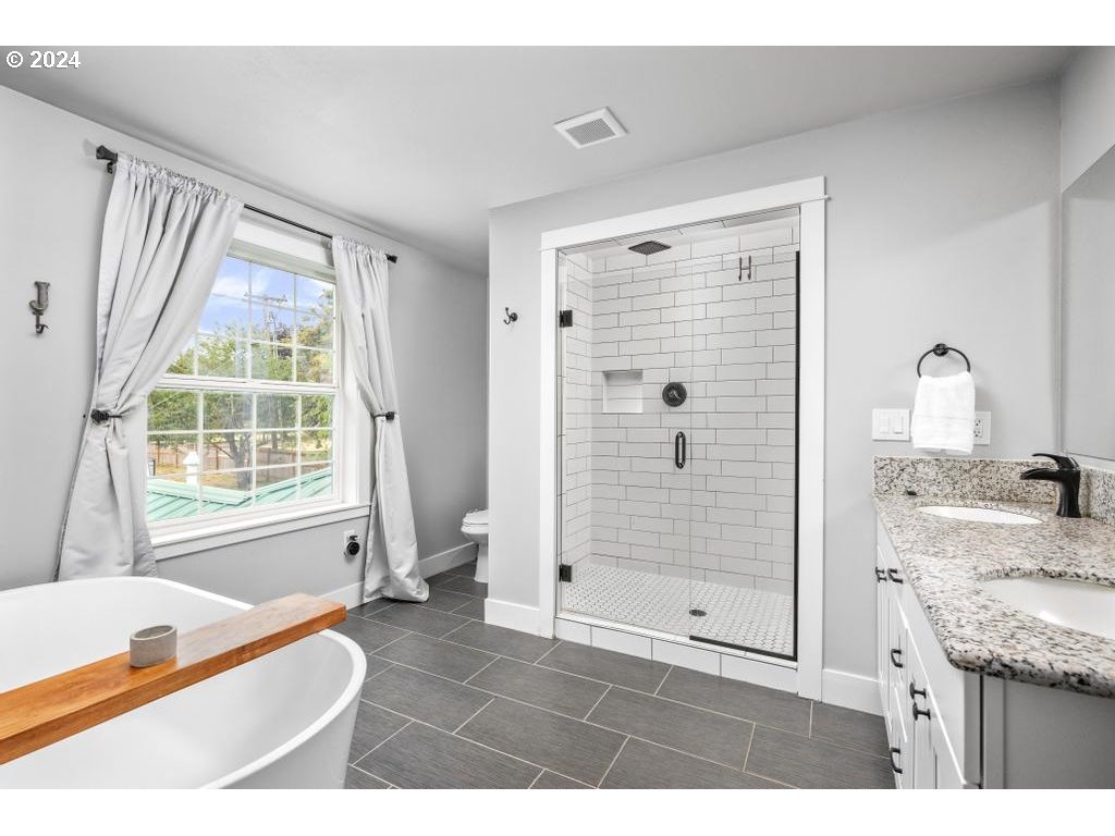 17762 South Redland Road Oregon City, OR 97045 - Photo 21 of 37 a bathroom with a granite countertop sink a mirror and shower