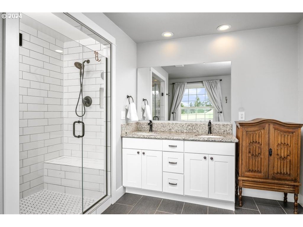 17762 South Redland Road Oregon City, OR 97045 - Photo 22 of 37 a bathroom with a granite countertop sink a mirror a vanity and a shower