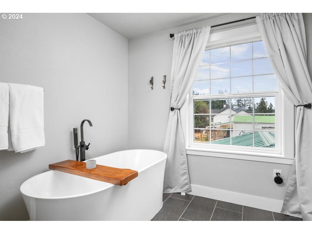 17762 South Redland Road Oregon City, OR 97045 - Photo 23 of 37 a bathroom with a sink a mirror and a window