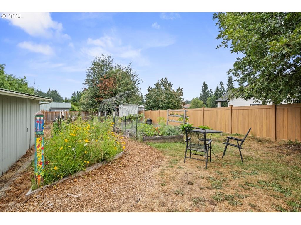 17762 South Redland Road Oregon City, OR 97045 - Photo 33 of 37 a view of a bench in the garden near a lake