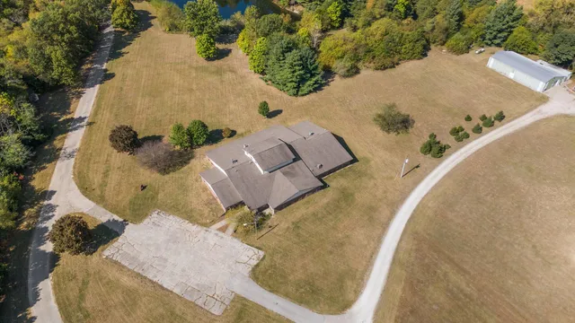 a view of a house with backyard and sitting area