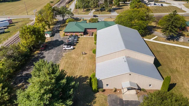 a living room with furniture kitchen view and a large window