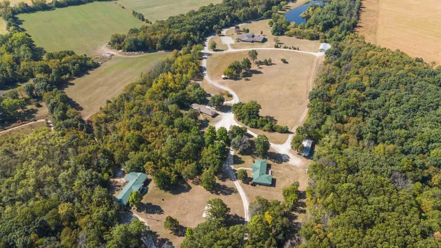 an aerial view of a house with outdoor space