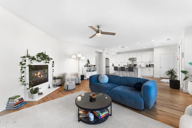a living room with furniture a rug and a fireplace