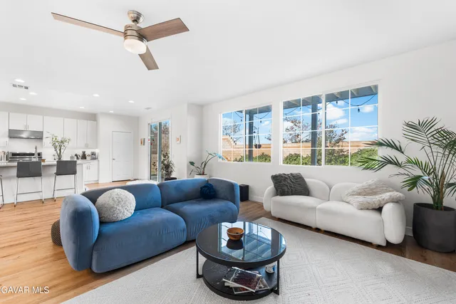 a living room with furniture and a large window