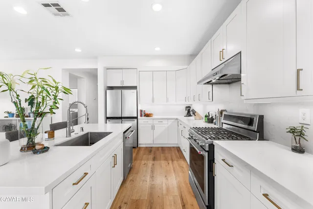 a kitchen with a sink stove and cabinets