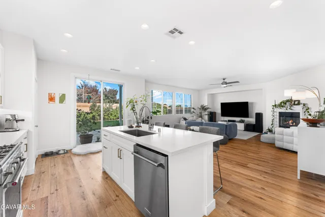 a large white kitchen with sink stove and refrigerator
