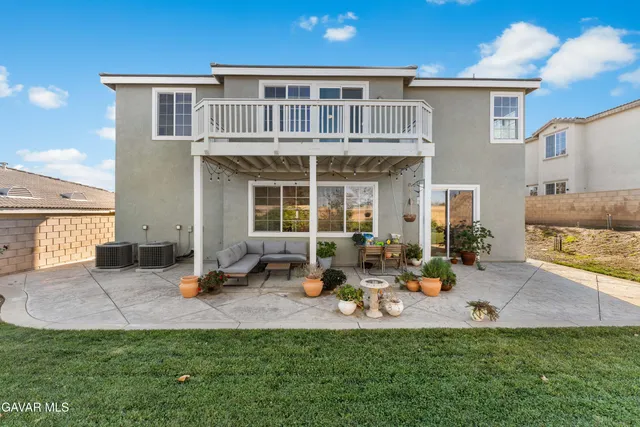 a group of people sitting in front of a house