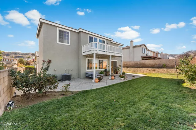 a view of a house with a yard patio and sitting area
