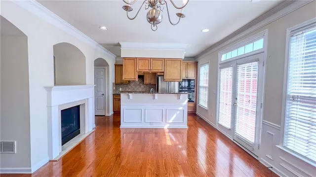 a view of living room with furniture a fireplace and wooden floor