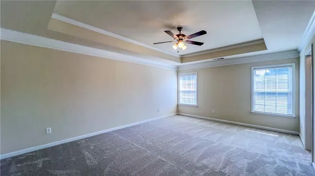 a view of empty room with ceiling fan