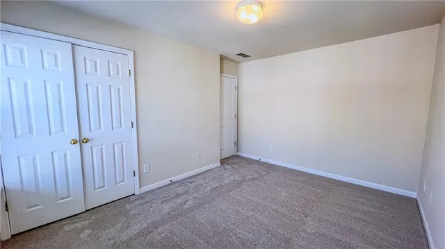 an empty room with a empty space and windows