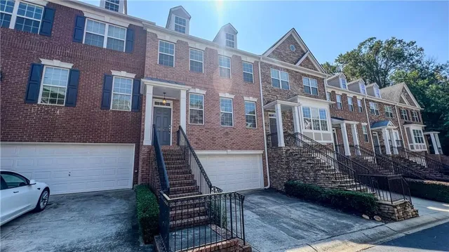 a view of a brick house with many windows