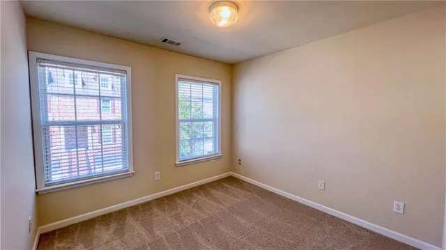 a bathroom with a granite countertop bathtub shower and toilet