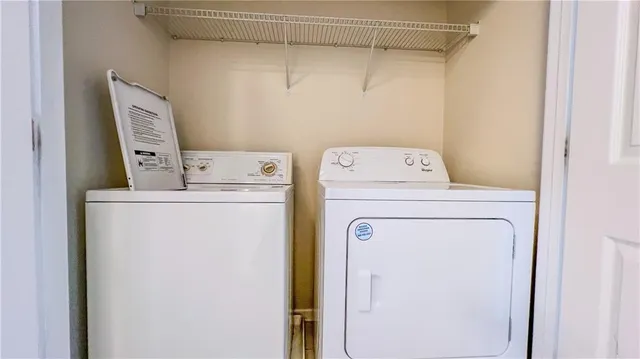 a view of an empty room with closet and a window
