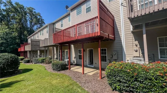 a view of a garden with large trees