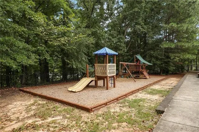 a view of a street with houses on both side of the road