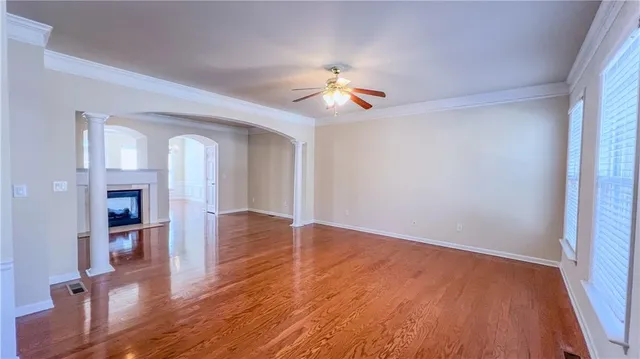 wooden floor in an empty room with a window
