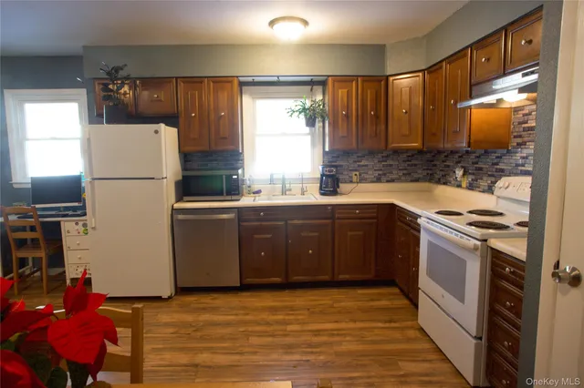 a kitchen with a sink stove and refrigerator
