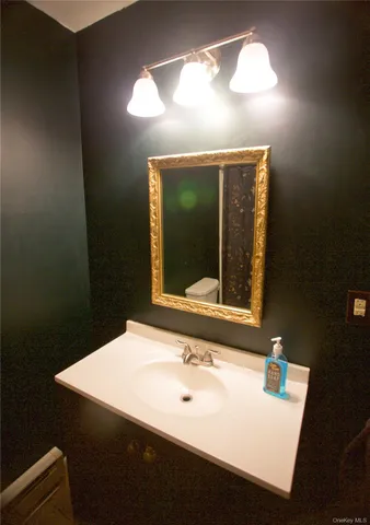 a bathroom with a sink vanity and a mirror