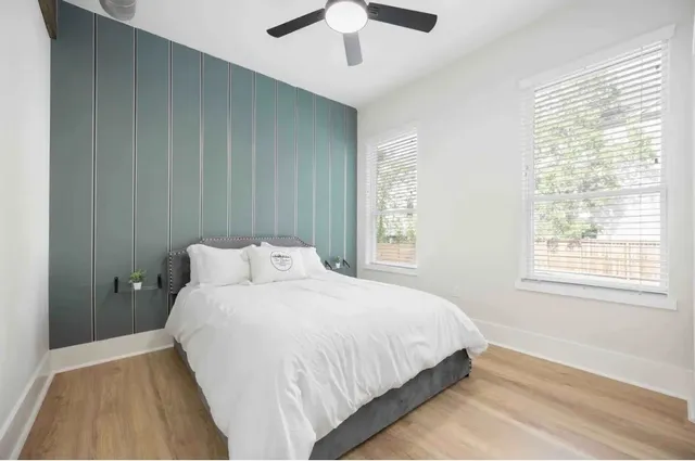 a bedroom with a bed and a large window